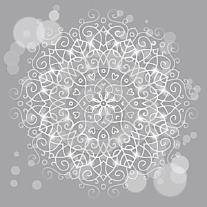 Abstract grey background with a round mandala ornament, sparkles
