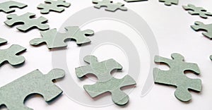 Abstract grey jigsaw puzzle pieces on white background