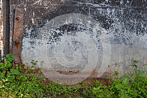 Abstract grunge background. The lower left side of the old garage door.