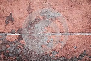 Abstract grunge texture of old colorful block wall with grain and scratches.Pink, red, peachy and grey