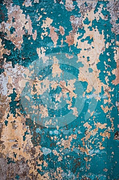 Abstract grunge texture of old colorful wall with peeled off blue paint. Creative background. Green, grey, blue and orange