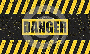 Abstract grunge yellow danger sign on a black background