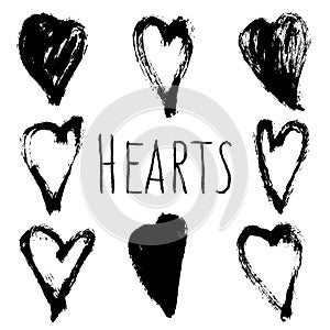 Abstract hand drawn set of black brush in the shape of a heart, drops and strokes of paint, ink, splash, grunge. Isolated vector