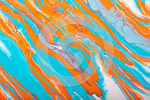 Abstract handmade composition made in the technique of fluid art. Bright art project in trendy shades of orange coral and