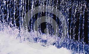 Abstract high contrast image of water flowing down a fountain