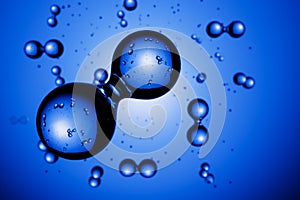 Abstract hydrogen molecules H2 in front of blue vignetted background