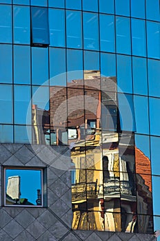 Abstract image as a reflection of old style buildings in a glass of super modern building at downtown of Vienna