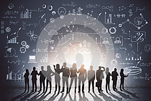 Abstract image of backlit businesspeople standing on blackboard wall background with creative business sketch. Teamwork, success,