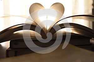 Abstract image of book with open page folded a heart shape