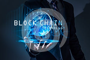 The abstract image of the business man hold the blockchain hologram on hand and element of this image furnished by Nasa.