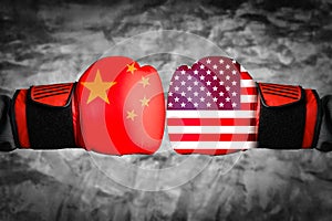The abstract image of the businessman wearing a boxing mitts overlay with cityscape and Chinese,USA. flag image. the concept of fi