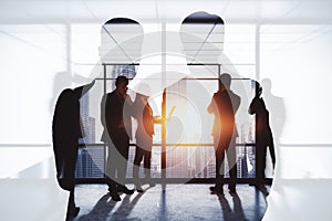 Abstract image of businessmen and women working together on abstract city office background with daylight. Teamwork and finance
