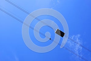Abstract image of a cable car against the blue sky