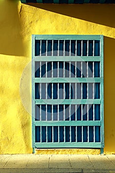 Abstract image of colorful yellow wall with blue door