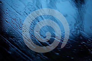 Abstract image of drops in the rain on Car Mirror.