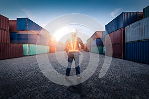 The abstract image of the engineer standing in shipping container yard and copy space. the concept of engineering, shipping, shipy