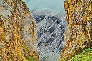 Abstract image of the entrance to an alpine valley formed on the sides by steeply rising rocks