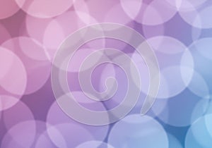 An abstract image featuring a bokeh effect, displaying soft, overlapping circles in