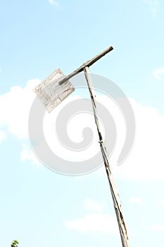 abstract image of an incomprehensible wooden object on the background of a blue sky