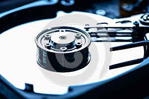 The abstract image of inside of hard disk drive on the technician`s desk. the concept of data, hardware, and information technolog