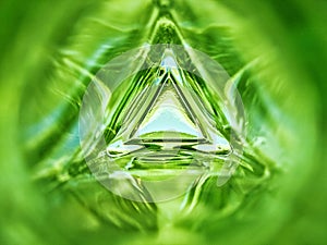 Abstract image of the inside of a triangle glass bottle emerald green color background