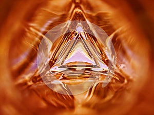 Abstract image of the inside of a triangle glass bottle red color background
