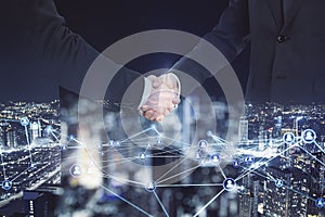 Abstract image of men shaking hands on blurry glowing polygonal network with people icons city background. Online networking,