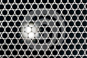 Abstract image of metal pipes showing light on the other end.Background texture.
