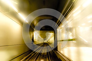 Abstract image of motion blurred tracks, tunnel and glass subway doors in Copenhagen, Denmark