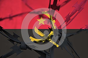 Abstract image of the national flag of Angola with twisted barbed wire.