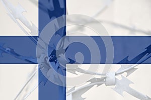 Abstract image of the national flag of Finland with twisted barbed wire.