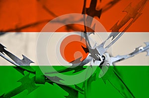 Abstract image of the national flag of Niger with twisted barbed wire