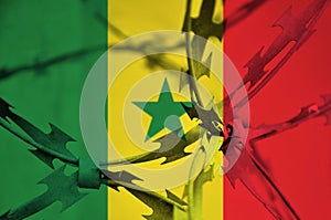 Abstract image of the national flag of Senegal with twisted barbed wire