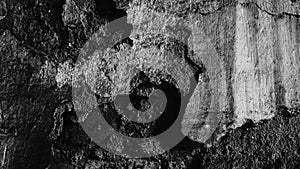 Abstract image of an old wall, broken plaster with old, partly broken bricks below, aged with long time