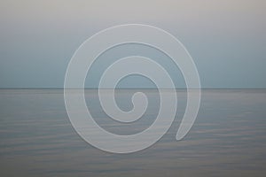 Abstract image of the sea and blue sky in evening at sunset with soft blurry sharpness and pleasant soft colors