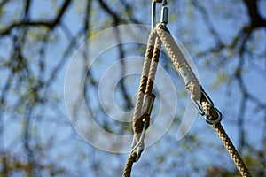 Abstract image of swing rope with blurred trees in the background