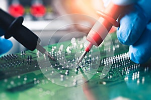 The abstract image of the technician using voltage meter for voltage measurement in computer mainboard.