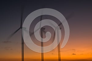 Abstract image of a windfarm against an African Sunset