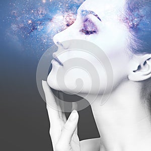 Abstract image of woman face and cosmic galaxy.