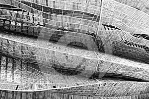 Abstract image of wooden lath pattern show curved structure in black and white. Image use biodegradable natural materials.