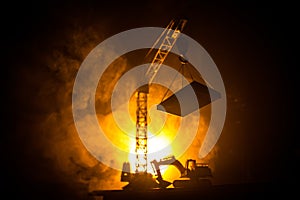 Abstract Industrial background with construction crane silhouette over amazing sunset sky. Tower crane against the evening sky.