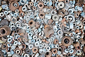 Abstract industrial old background with rusty used nuts for wallpaper many metalware photo