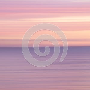 abstract landscape of sea. texture water, sky and sand in blurry motion in tropical sunset colors