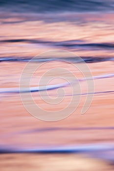 abstract landscape of sea. texture water, sky and sand in blurry motion in tropical sunset colors