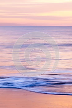 abstract landscape of sea. texture water, sky and sand in blurry motion in tropical sunset colors