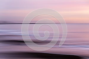 abstract landscape of sea. texture water, sky and sand in blurry motion in tropical sunset colors