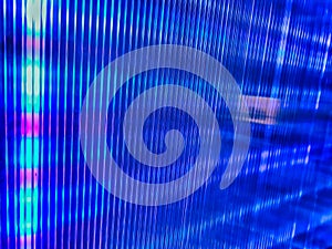 Abstract led light trails on the dark background. Shine metal texture. Defocused christmas lights on blue colors tone. Moving