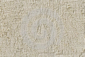 Abstract light beige grainy background with the texture of coarse grained new decorative plaster. Construction and repair.