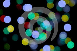 Abstract light bokeh colorful on black background using as a wallpaper taxture