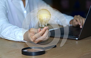 Abstract light bulb and magnifying glass concept Business people show new ideas by using innovative technology and creativity